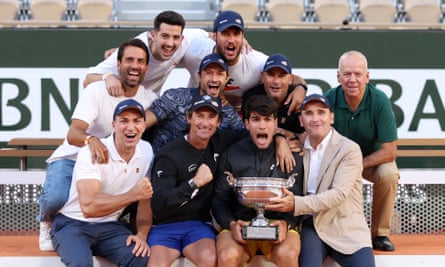 Carlos Alcaraz poses with members of his team after beating Alexander Zverev to win the 2024 French Open