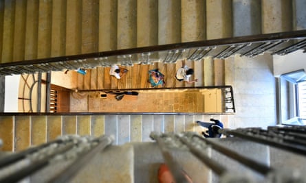 People seen from the top of a spiral staircase