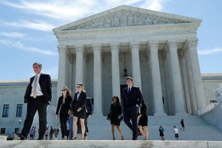 People walk out after the US supreme court granted parts of the Trump administration’s emergency request to put his travel ban into effect immediately while the legal battle continues.