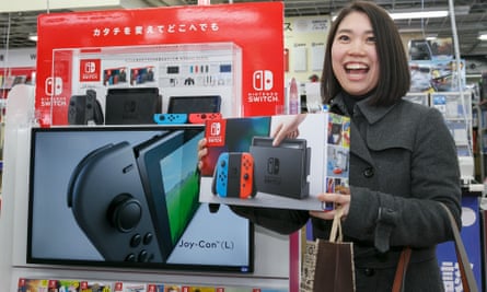 ‘We’re trying to find ways to make people happy’ … a player with a Nintendo Switch in Tokyo.