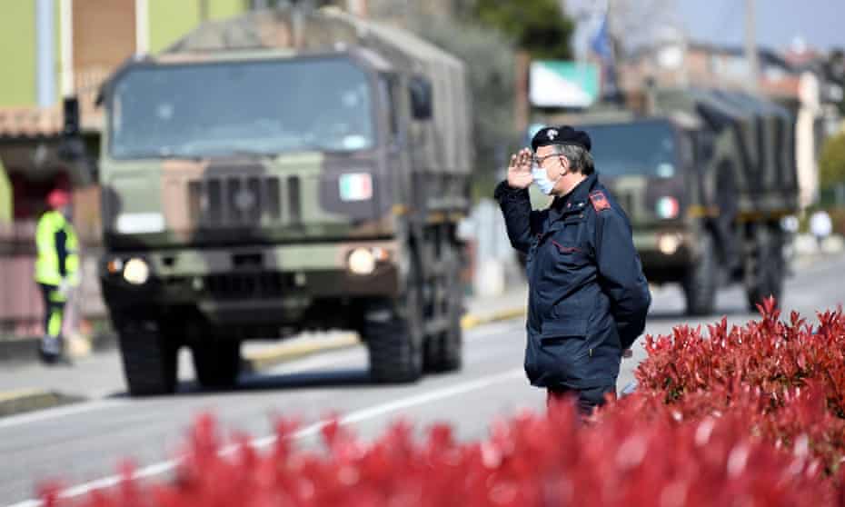 Military trucks take away coffins in Seriate, Lombardy, in March.