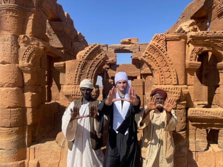 Mofid in Sudan in his graduation gown, with local villagers.