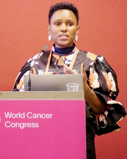 Gloria Chinyere Okwu speaking behind a lectern with the World Cancer Congress sign on it.