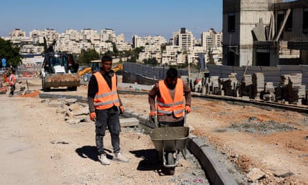 Palestinian labourers work at a construction site in the occupied West Bank