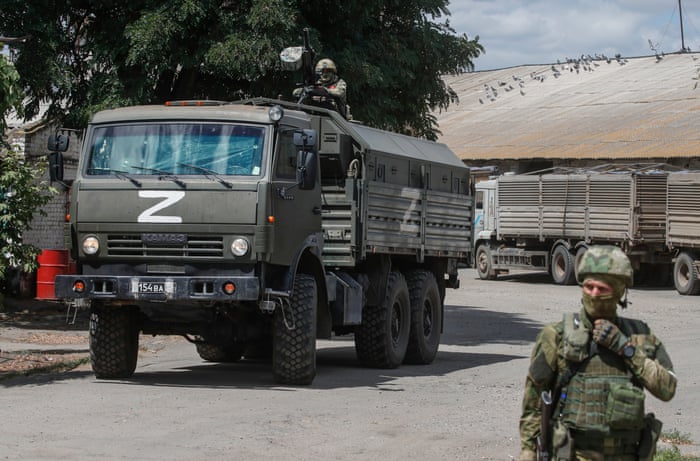Russian servicemen guardian a grain storage facility in occupied Melitopol. Ukraine has repeatedly accused Russia and pro-Russian forces of stealing and exporting its grain.