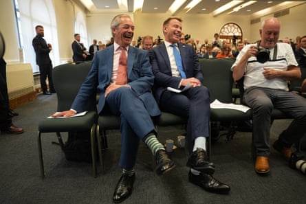 Farage and Bull laugh while seated alongside each other