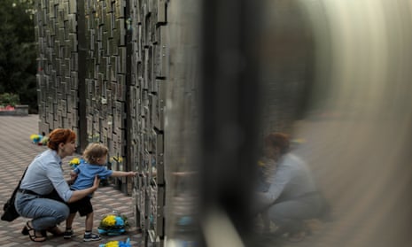 People visit a memorial for victims of executions and attacks by Russian troops in Bucha, Kyiv.