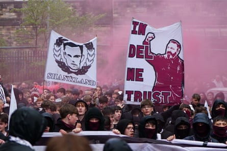 Hearts fans outside the stadium holding a banner celebrating their player Lawrence Shankland, and their manager ('In Del We Trust')