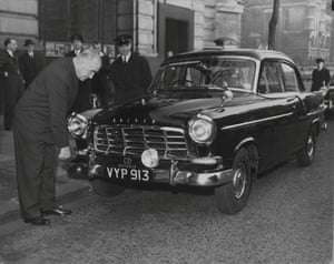 Sir Eric Harrison, the Australian high commissioner in London, inspects the first of five 1958 Holden sedan cars to arrive at Australia House in London, in December 1958