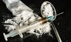 A drug syringe and a spoon with cooked heroin<br>Drug syringe and cooked heroin on spoon