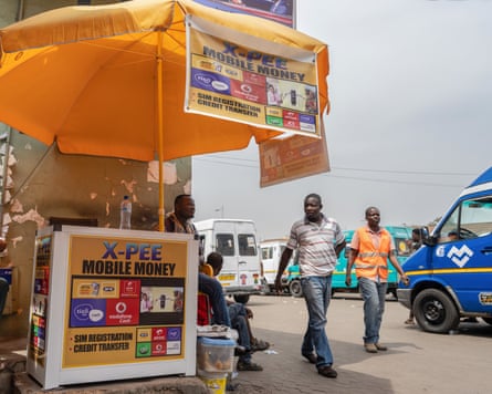 ‘You feel obligated’: African workers on the pain – and pride – of the ‘black tax’ A mobile money and sim card kiosk in Accra, Ghana