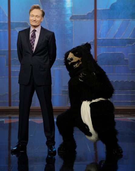 conan stands next to person in bear costume reaching for its genitals
