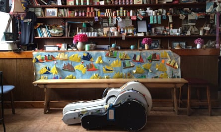 Two guitar cases on the floor in front of the grocery counter at Levis Corner House Ballydehob, West Cork, Ireland.