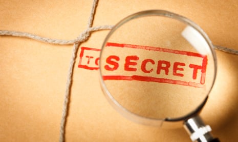 A magnifying glass over "top secret" stamped on an envelope