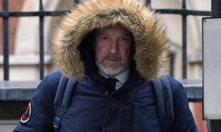 Michael Lousada, wearing a large hooded jacket, leaves the Royal Courts of Justice in London