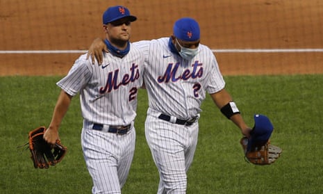 JD Davis and Dominic Smith of the New York Mets leave the field after a protest against racism
