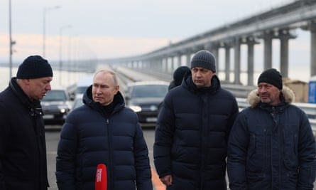 Vladimir Putin, second left, visiting the bombed Kerch bridge connecting Crimea and Russia early this month