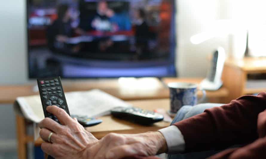 An elderly person watching TV