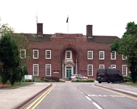The approach to a forbidding double-fronted brick building