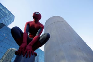 A man in a Spiderman costume poses utside the convention