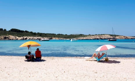 Beachgoers in Menorca, one of the Balearic islands