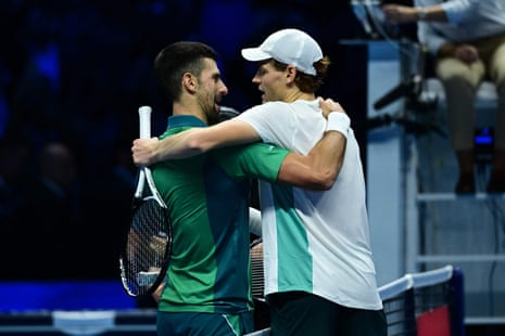 Djokovic and Sinner embrace at the net.