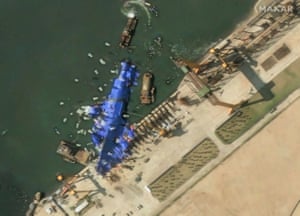 A satellite image shows a North Korean warship covered with blue tarpaulin after an accident that occurred during its launch at the shipyard in Chongjin