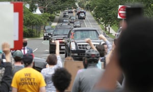 Demonstrators scream and thrust their fists in protest as Donald Trump’s limousine and motorcade approach in Washington Tuesday.