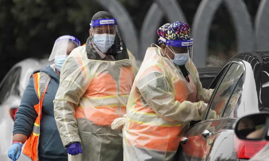 Workers administer a Covid-19 vaccine at a Los Angeles county site at California State University Northridge on Tuesday.