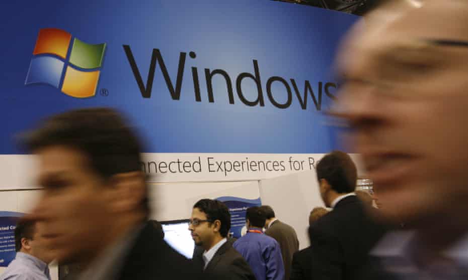 People in front of Microsoft Windows sign