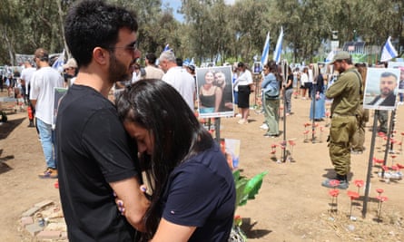 People observe two minutes of silence on Yom HaZikaron, Memorial Day, on 13 May, 2024, at the site of the Supernova music festival.