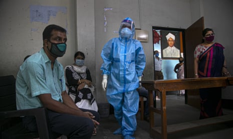 An Indian health worker prepares to take nasal swab samples of teachers in Gauhati, India, Wednesday, 2 September 2020.