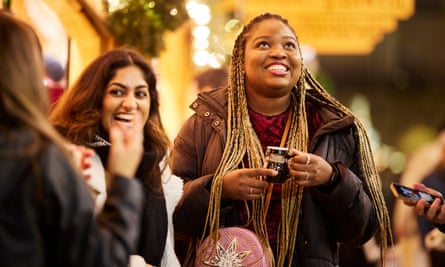 Two women smiling at a Christmas market