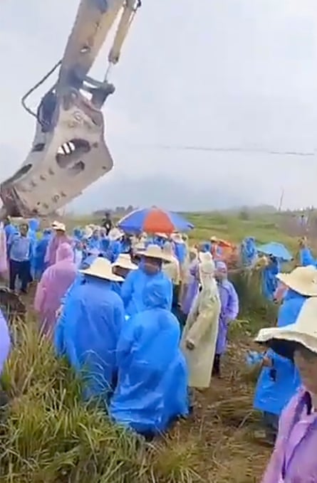 Screenshot from a video of dozens of people in a village in Hunan province, China, gather during an apparent dispute over the seizure of farmland in farmland in Tongxing village in September.