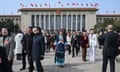 Delegates leave after participating in preparatory meetings for the third session of the 14th National Congress of the People in the Great Hall of Beijing