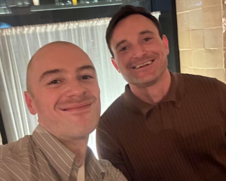 Two young men - one in stripy shirt one in dark shirt