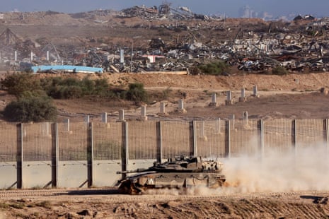 An Israeli army tanks rolls along the separation fence on the border with the Gaza Strip in southern Israel, on Wednesday.