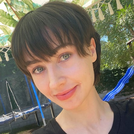 A woman with short dark hair and a black t-shirt