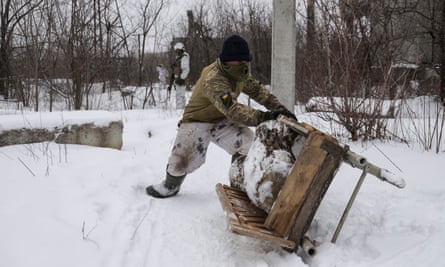 Ukrainian serviceman stores up firewood on a frontline near the Avdiivka village, not far from pro-Russian militants controlled city of Donetsk, Ukraine, on Tuesday.
