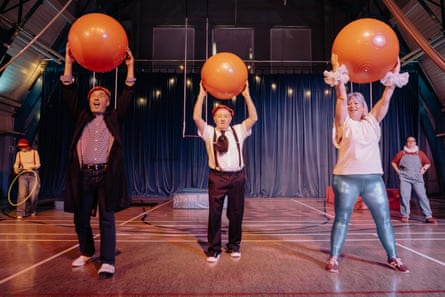 Three people holding orange balls above their heads