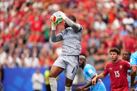 DR Congo keeper Lionel Mpasi claims the ball.