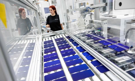 An employee oversees the production process of solar cells at a machine at the solar cell plant of Swiss group Meyer Burger in Bitterfeld-Wolfen, eastern Germany on 26 September 2023.