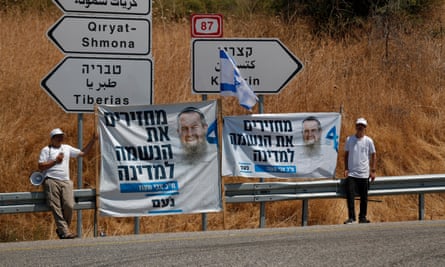 Activists holding election campaign banners in support of Avi Maoz near the Sea of Galilee