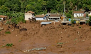 Houses perched on the edge of the river after the deluge had passed.