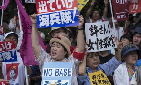 Protesters holding signs saying 'No base' in Okinawa, Japan