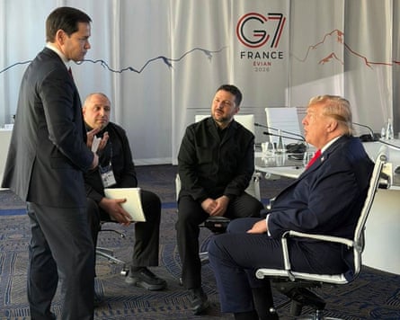 The US secretary of state, Marco Rubio, the Ukrainian defence minister, Rustem Umerov, Ukraine’s president, Volodymyr Zelenskyy, and the US president, Donald Trump, talking in a room in front of curtains bearing G7 logos