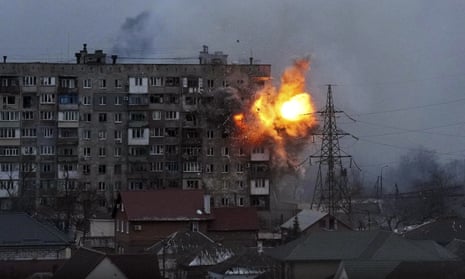 An explosion is seen in an apartment building after a Russian army tank fires in Mariupol, Ukraine, on 11 March