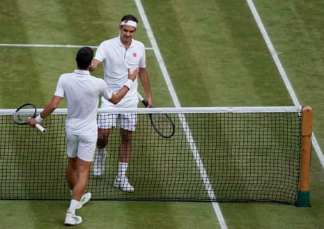 Novak Djokovic greets Roger Federer after winning.