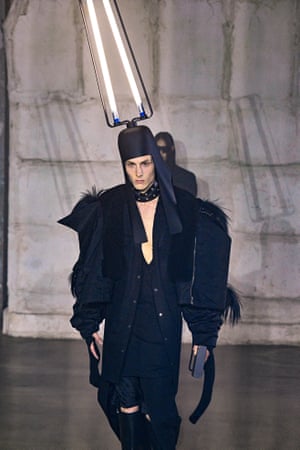 Rick OwensAt Rick Owens, models strode around Palais de Tokyo in vertiginous heels under manically flickering lights for the collection titled ‘Strobe’. Some wore Dan Flavin-like lightbulb helmets, inspired by ancient Egyptian crowns, that doubled as free-standing lamps. Coats and jackets kept the exaggerated shoulders that, said Owens, ‘I started doing as a parody of menswear but ended up enjoying wearing... an excuse to take up more space around me’. Hoods came fully zipped as masked life has made a faceless face the norm.