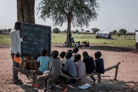 A makeshift school at the Bok Chop IDP camp. The children lack pencils, blackboards and books and even enough mats to sit on the floor.